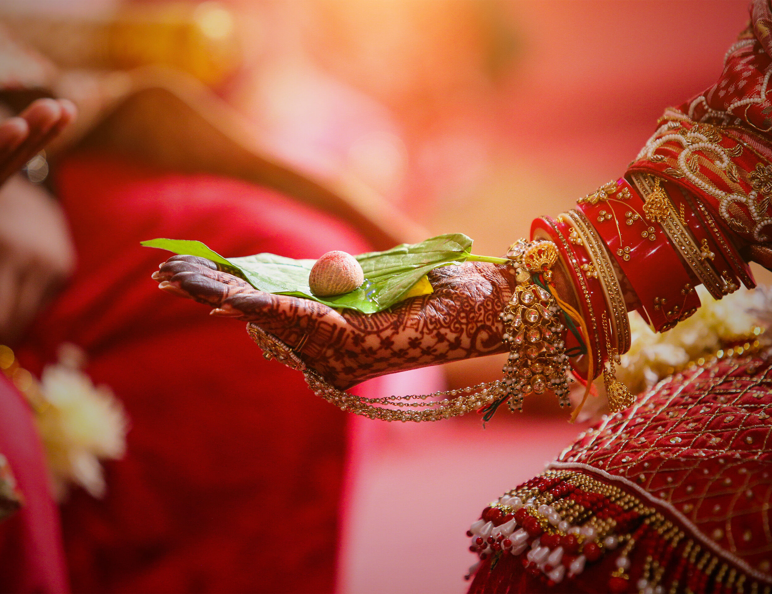 A bride having leaf and supari on her hand for wedding rituals